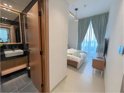 a bedroom with a bed and a sink and a mirror at Solysian Stay in Dubai
