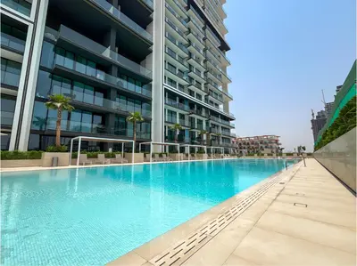 an empty swimming pool in front of a building at Solysian Stay in Dubai