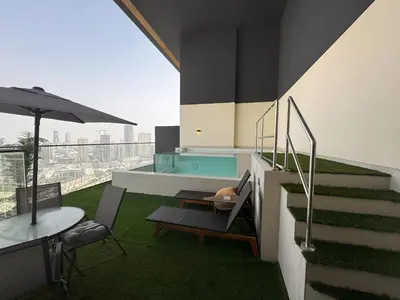a house with a swimming pool and a table and chairs at Solysian Stay in Dubai