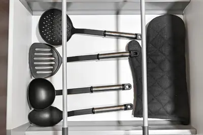 a rack of kitchen utensils in a drawer at Stylish Apartment with Balcony and Pool, Close to Dubai's Top Landmarks in Dubai