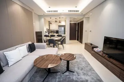 a living room with a white couch and a table at Highlife Haven in Dubai with Pool and Gym in Dubai