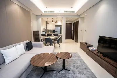 a living room with a white couch and a table at Highlife Haven in Dubai with Pool and Gym in Dubai