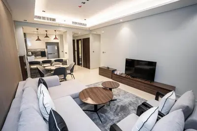 a living room with a couch and a tv at Highlife Haven in Dubai with Pool and Gym in Dubai