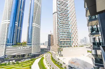 a view of a city with tall buildings at Luxe 1BR Suite Dubai Dream Stay with Pool and Gym in Dubai