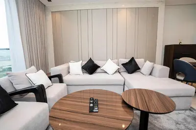 a living room with two couches and a table at Cityscape Retreat Nobles 2BR Nobles Edition in Dubai