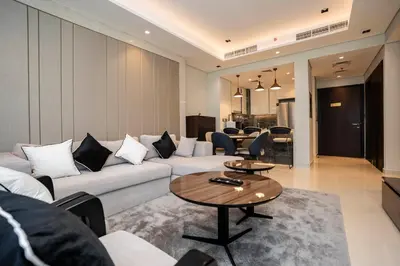 a living room with a couch and a table at Cityscape Retreat Nobles 2BR Nobles Edition in Dubai