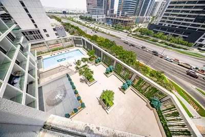 an overhead view of a building with a pool and a street at Modern Studio I Smart Home I Business Bay in Dubai