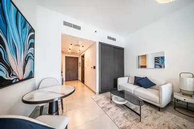 a living room with a couch and a table at Modern Studio I Smart Home I Business Bay in Dubai