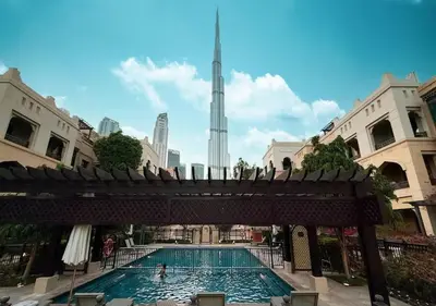 a swimming pool with a view of the burj tower at Luxury 2BR- Pool with Burj View- 2 Min to Dubai Mall in Dubai
