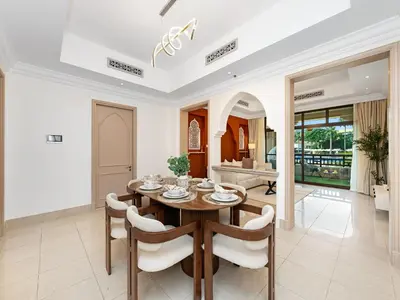 a dining room with a table and chairs at Luxury 2BR- Pool with Burj View- 2 Min to Dubai Mall in Dubai