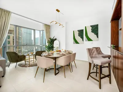 a dining room with a table and chairs at Luxury two Bedroom Apartment I Front row Downtown with Private Fountain & Burj View by Luxury Space in Dubai