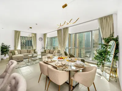 a living room with a table and chairs at Luxury two Bedroom Apartment I Front row Downtown with Private Fountain & Burj View by Luxury Space in Dubai
