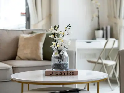 a vase with flowers on a table in a living room at Luxury two Bedroom Apartment I Front row Downtown with Private Fountain & Burj View by Luxury Space in Dubai