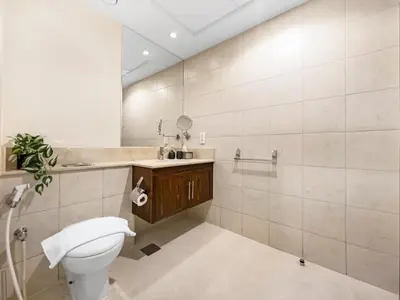a bathroom with a toilet and a sink at Luxury two Bedroom Apartment I Front row Downtown with Private Fountain & Burj View by Luxury Space in Dubai
