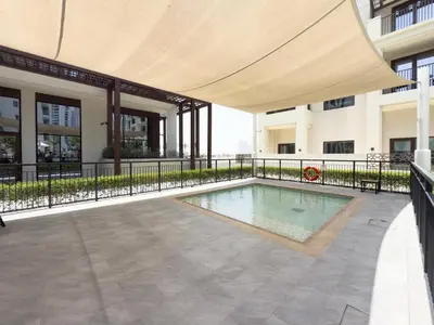 a swimming pool with a canopy on a building at GuestReady - Charming stay at Creek Beach in Dubai