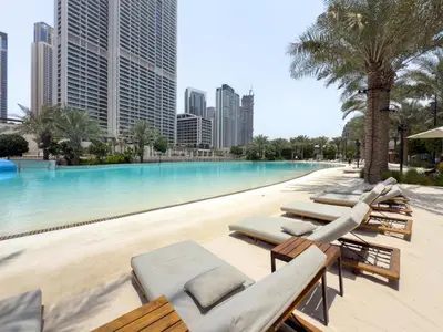 a swimming pool with chaise lounges and a resort at GuestReady - Charming stay at Creek Beach in Dubai