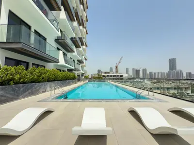 a swimming pool on the side of a building at Smart Home 1BR with Pool and City View in JVC by Bhavan Vacation Homes in Dubai