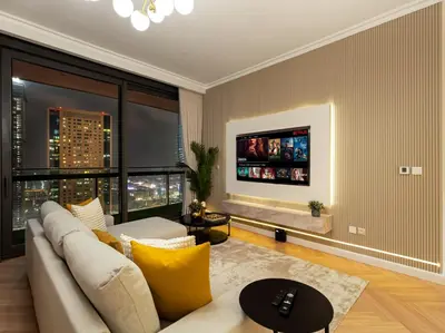 a living room with a couch and a large window at Kensington 2BR walk to Dubai Mall via Link in Dubai