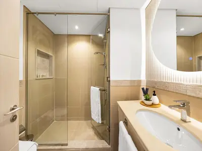 a bathroom with a shower and a sink and a tub at Kensington 2BR walk to Dubai Mall via Link in Dubai