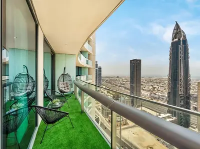 a balcony with chairs and a view of a city at Kensington 2BR walk to Dubai Mall via Link in Dubai