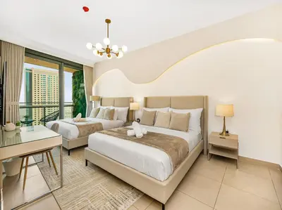 a bedroom with two beds and a balcony at Kensington 2BR walk to Dubai Mall via Link in Dubai