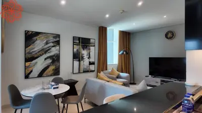 a living room with a couch and a table at pearl 1bdr apartment in business bay in Dubai