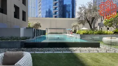a swimming pool in the middle of a building at pearl 1bdr apartment in business bay in Dubai