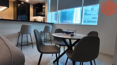 a dining room with a table and some chairs at pearl 1bdr apartment in business bay in Dubai