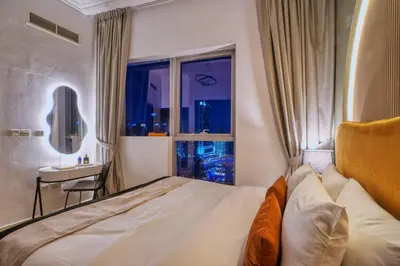 a bedroom with a large bed and a window at Panoramic Marina Views Walk to Beach and JBR 1BR in Dubai