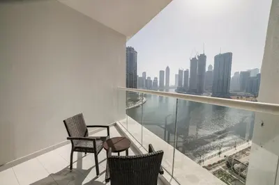 a balcony with chairs and a view of the city at Canal Bliss Balcony View in Dubai