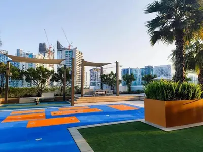 a patio with a blue and orange floor and trees at Canal Bliss Balcony View in Dubai