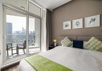 a bedroom with a bed and a large window at Canal Bliss Balcony View in Dubai