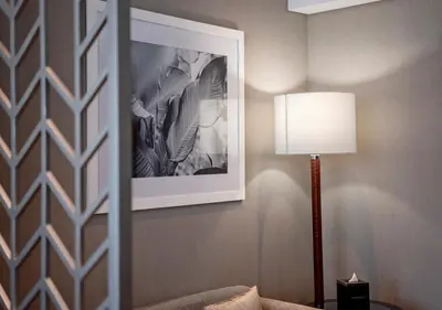 a room with a lamp and a picture on the wall at Canal Bliss Balcony View in Dubai