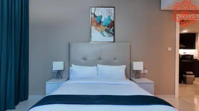 a bedroom with a large bed with blue curtains at Amazing 1bdr apartment in business bay in Dubai