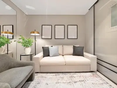 a living room with a white couch and two pillows at Kensington 1BR and Study with Sofa Bed Burj View Dubal mall link in Dubai