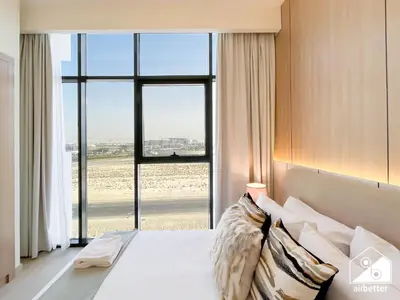 a bedroom with a bed and a large window at Serene Luxe l Modern 1BR in Meydan with Pool in Dubai