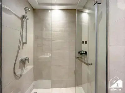 a shower with a glass door in a bathroom at Serene Luxe l Modern 1BR in Meydan with Pool in Dubai