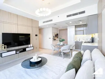a living room with a white couch and a table at Serene Luxe l Modern 1BR in Meydan with Pool in Dubai