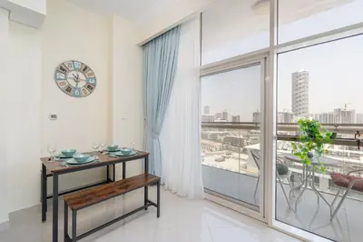 a room with a table and a large window at Bright and Cozy 1BHK JVC by Czechin Great Location in Dubai