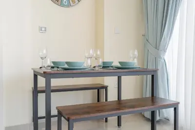 a table with glasses and plates on top of it at Bright and Cozy 1BHK JVC by Czechin Great Location in Dubai