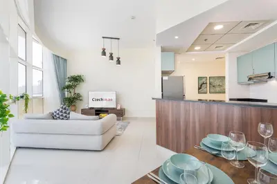 a living room with a couch and a table at Bright and Cozy 1BHK JVC by Czechin Great Location in Dubai