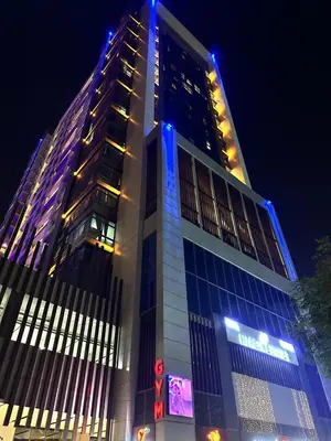 a tall building with blue lights on top of it at Modern Private Hostel Room near Business Bay Downtown in Dubai