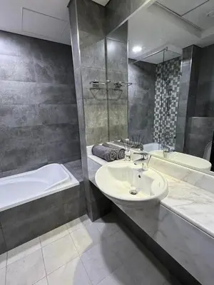 a bathroom with a sink and a bath tub and a tubermott at Modern Private Hostel Room near Business Bay Downtown in Dubai