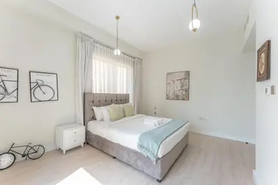 a white bedroom with a bed and a window at Veluxa - Beautiful 2Bed in JBR in Dubai
