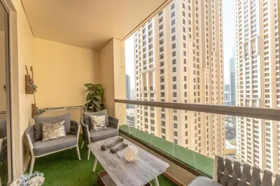 a balcony with a table and chairs and large windows at Veluxa - Beautiful 2Bed in JBR in Dubai