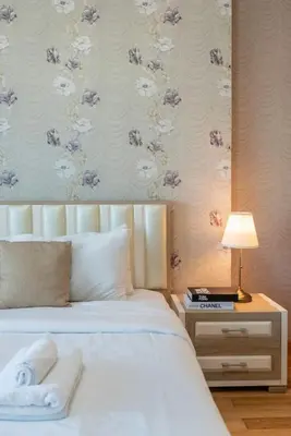 a bedroom with a bed and a table with a lamp at Marina View, 2BR Ideal for Groups, Walk to beach in Dubai