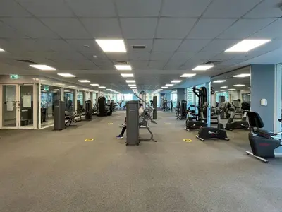 a gym with lots of treadmills and exercise bikes at Marina View, 2BR Ideal for Groups, Walk to beach in Dubai