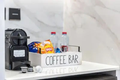 a white shelf with a coffee bar sign on it at Large 1BR, Pool View, Near Circle Mall, Parking in Dubai