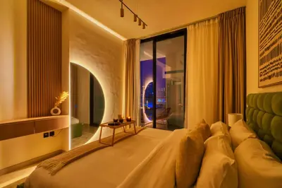 a bedroom with a large bed and a large window at Large 1BR, Pool View, Near Circle Mall, Parking in Dubai