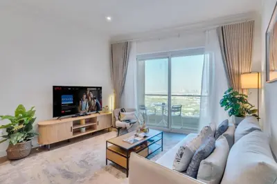 a living room with a couch and a tv at Family and Group Friendly Near Beach Metro and Marina in Dubai